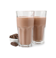Tasty chocolate milk in glasses and pieces of chocolate isolated on white
