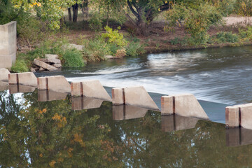 small dam diverting water for farmland irrigation - Cache la Poudre River above Greeley in northern...