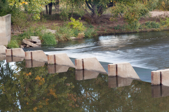 small dam diverting water for farmland irrigation - Cache la Poudre River above Greeley in northern Colorado