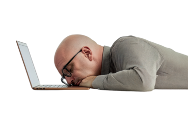 Exhausted man working on laptop