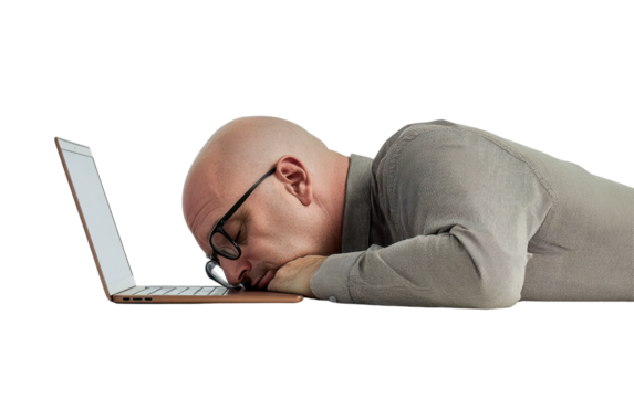 Exhausted man working on laptop
