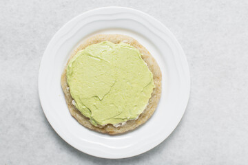 Overhead view of frosted lime and vanilla cookies, top view of bakery style lime cookies