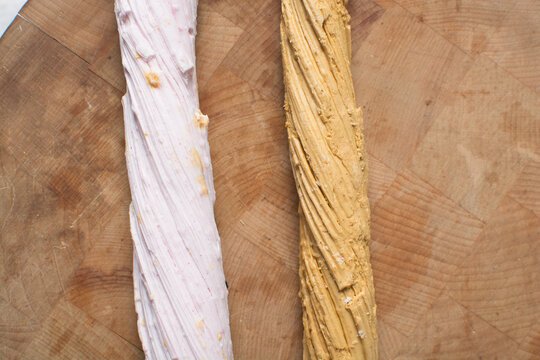 Overhead view of Nigerian Balewa candy in cellophane, top view of hausa alewa candy on a wood background, pulled hard sugar candy on a wood countertop