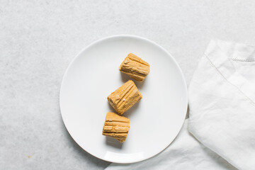 Overhead view of Nigerian Balewa candy, top view of hausa alewa candy on a white background, pulled hard sugar candy on a white countertop
