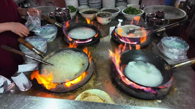 A halal rice noodle shop in Nanning, Guangxi, China is busy cooking rice noodles.