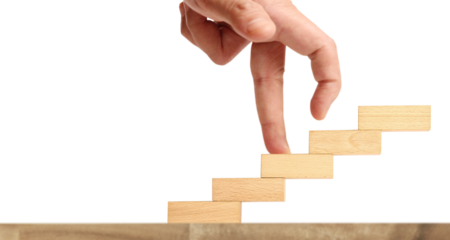 Creative hand reaching upward wooden blocks stacking minimalist design indoor setting close-up view concept of progress and growth