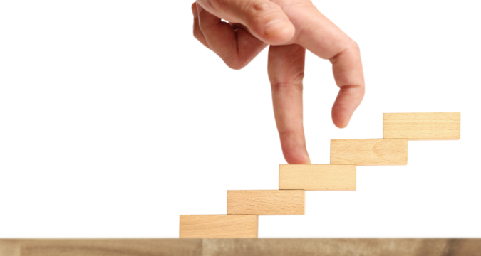 Creative hand reaching upward wooden blocks stacking minimalist design indoor setting close-up view concept of progress and growth