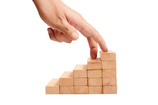 Building success hand placement on wooden blocks workshop skill development indoor environment close-up view growth concept