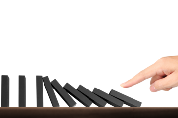 Domino effect demonstration indoor setting still life photography minimalist environment close-up view visual metaphor for cause and effect