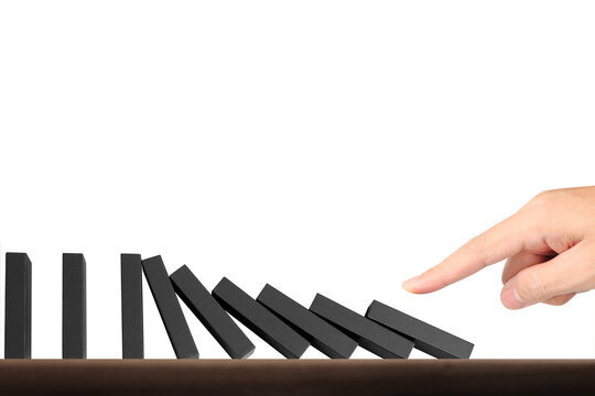 Domino effect demonstration indoor setting still life photography minimalist environment close-up view visual metaphor for cause and effect