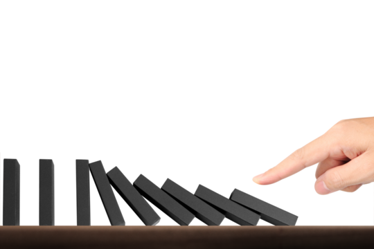 Domino effect demonstration indoor setting still life photography minimalist environment close-up view visual metaphor for cause and effect