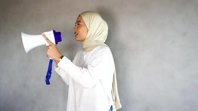 Footage of a woman holding a megaphone while ranting