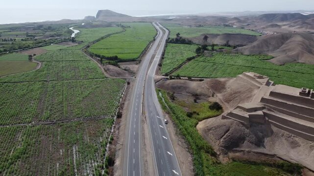 Panning aerial view of paramonga fortress, peru, and surrounding agricultural fields