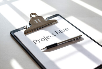 Project blue document on clipboard with pen for business planning and strategy development concept