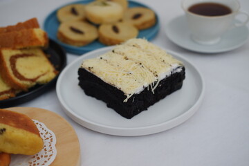 The cake is neatly sliced into several square portions