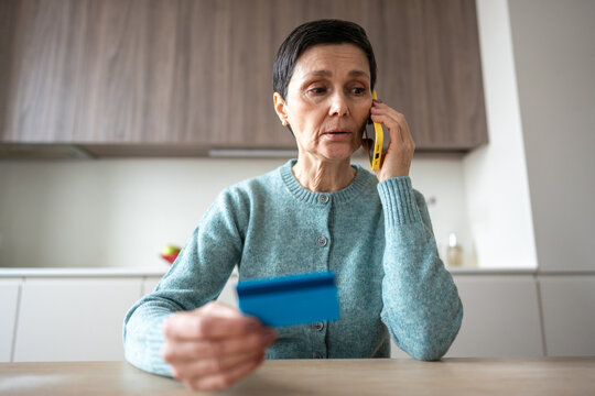 Scared nervous woman transferring money to scammers over phone. Fraud deception, bank card information theft, manipulation identity theft, financial crime, personal data exposure, vulnerable scam