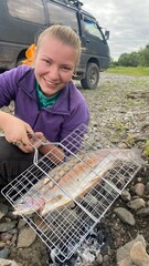 girl frying fish on fire