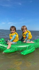 children are swimming in the sea