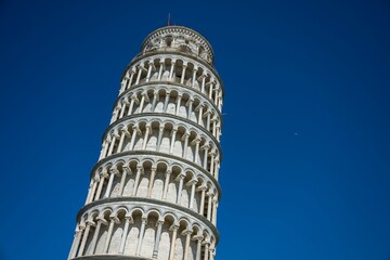 Iconic Leaning Tower of Pisa against a clear blue sky in Pisa, Italy