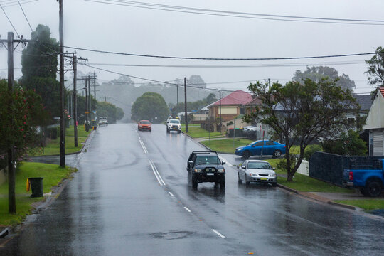 Rainy stormy day with vehicles driving on slippery wet road in Newcastle