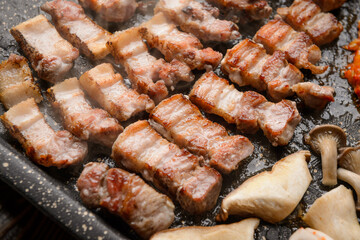 Pork grilling on a black grill
