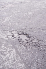 Pothole filled with rainwater on an urban street