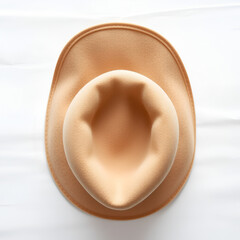 Top-down close-up view of a beige felt hat, emphasizing its wide brim and soft material, cleanly framed on a white canvas