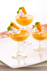 Sweet and luscious mango panna cotta served in stylish glasses. Topped with juicy mango and fresh mint leaves.