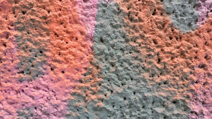 Colorful textured pattern featuring pink and gray shades on a wall surface providing an artistic background with copy space