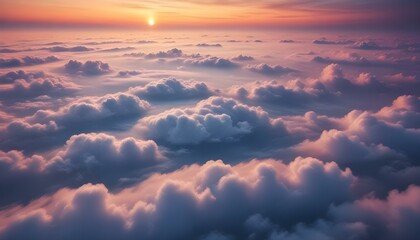 The sun paints the sky with warm hues as clouds drift in a breathtaking aerial landscape.