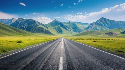 Naklejka premium Asphalt Road Leading to Majestic Mountain Range