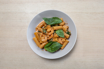 A plate of creamy prawn rigatoni pasta.