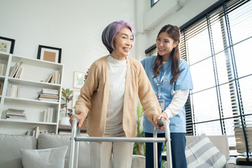 Young asian caregiver or woman nurse hand on senior female shoulder give support empathy to care,consulting and encourage,take a history and recommend the right treatment to live happily in retirement