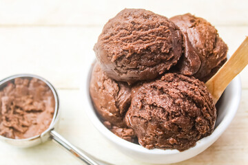 chocolate scoop ice cream in a bowl on a wooden table