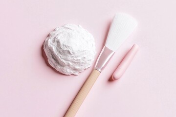 Cosmetic face mask and brush on pink background