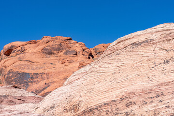 Fototapeta premium Aztec Sandstone(Jurassic) geological formation. weathering. Scenic Loop Dr, Red Rock Canyon National Conservation Area, Las Vegas, Clark County, Nevada. Mojave Desert. Basin and Range Province