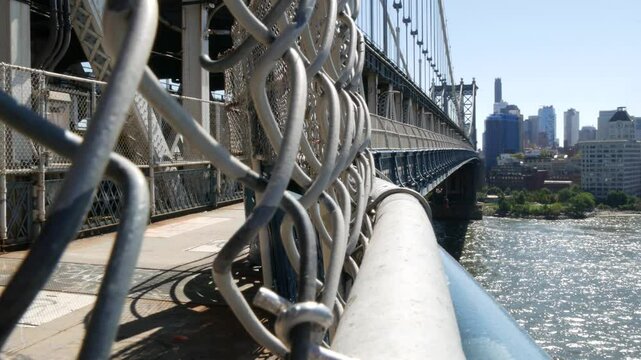 New York City Manhattan Bridge to Dumbo, Brooklyn. Waterfront skyline cityscape from pedestrian path. East river water. Riverfront architecture.