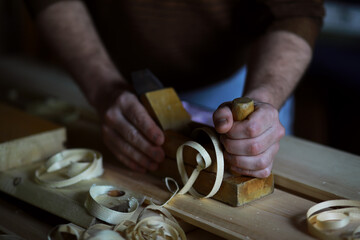 Plane jointer carpenter or joiner tool and wood shavings. Woodworking tools on wooden table. Carpentry workshop