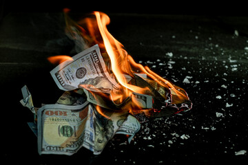 Stack banknote is burning on a black background