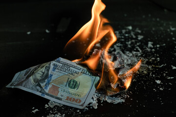 Stack banknote is burning on a black background