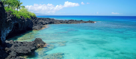 Obraz premium Azure ocean meets rugged black lava rock coastline in bright sunlight