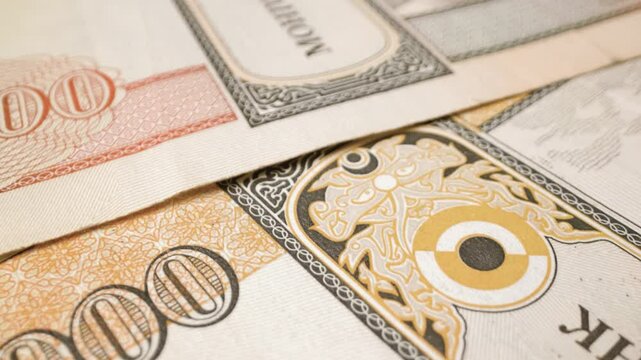 Extreme close-up of a 10,000-tugrik Mongolian banknotes in motion, highlighting intricate details and texture.