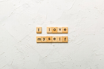I Love myself word written on wood block. I Love myself text on cement table for your desing,...