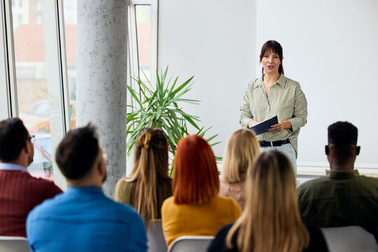 Presenter Speaking to Audience in Conference Room During a Business Seminar