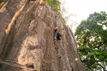 Rock Climber Ascending Cliff Face
