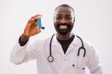 Portrait of  happy African doctor in medical uniform who is showing inhaler and promoting...