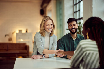 Team Collaboration in a Modern Office With Smiling Professionals at a Desk