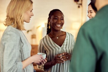 Group Of Friends Smiling and Talking Together at a Cozy Social Gathering