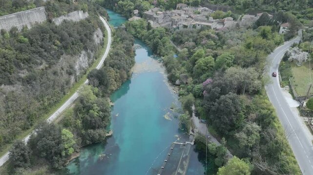 Drone footage of Stifone and the Morica spring in Umbria, Italy: turquoise waters, lush nature, stone ruins, and peaceful river views in a hidden, historic valley.