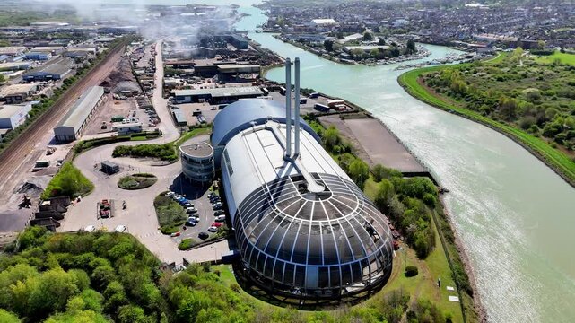 Stunning aerial drone footage of Newhaven ERF, an eco-friendly, modern facility converting non-recyclable waste into green energy for the National Grid. Set by the River Ouse, amid lush gardens.